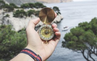 Holding a compass on a trail Holding a compass on a trail