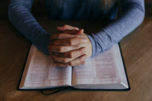Man praying over Bible