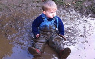 Boy wearing muddy clothes