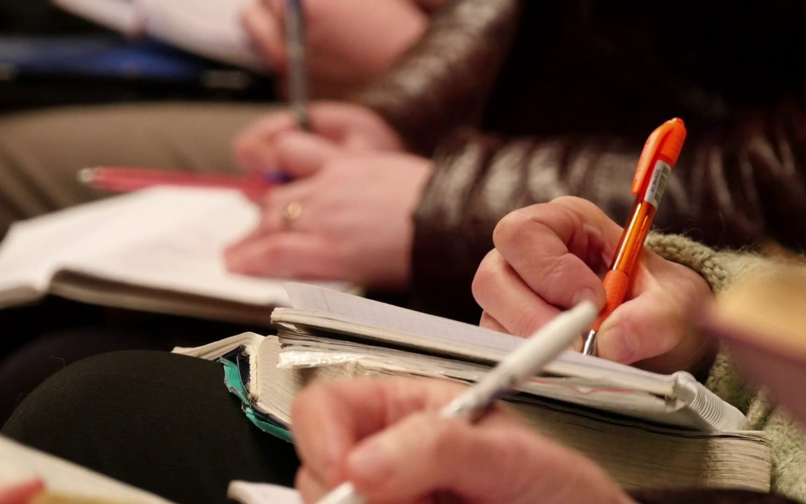 People taking notes during sermon