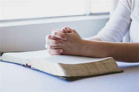 Praying hands on Bible